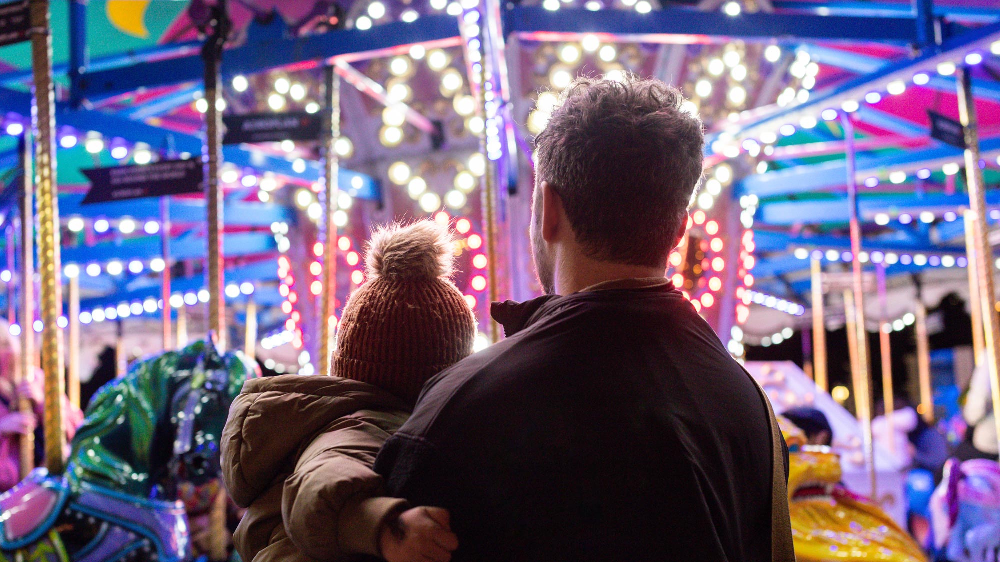 A family enjoying the lights at the Vancouver Christmas Market