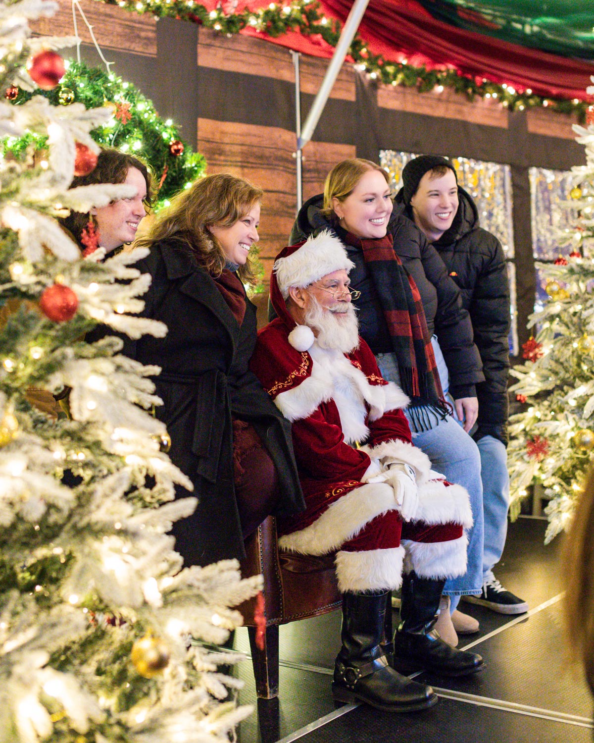 Friends taking a photo with Santa at the Vancouver Christmas Market